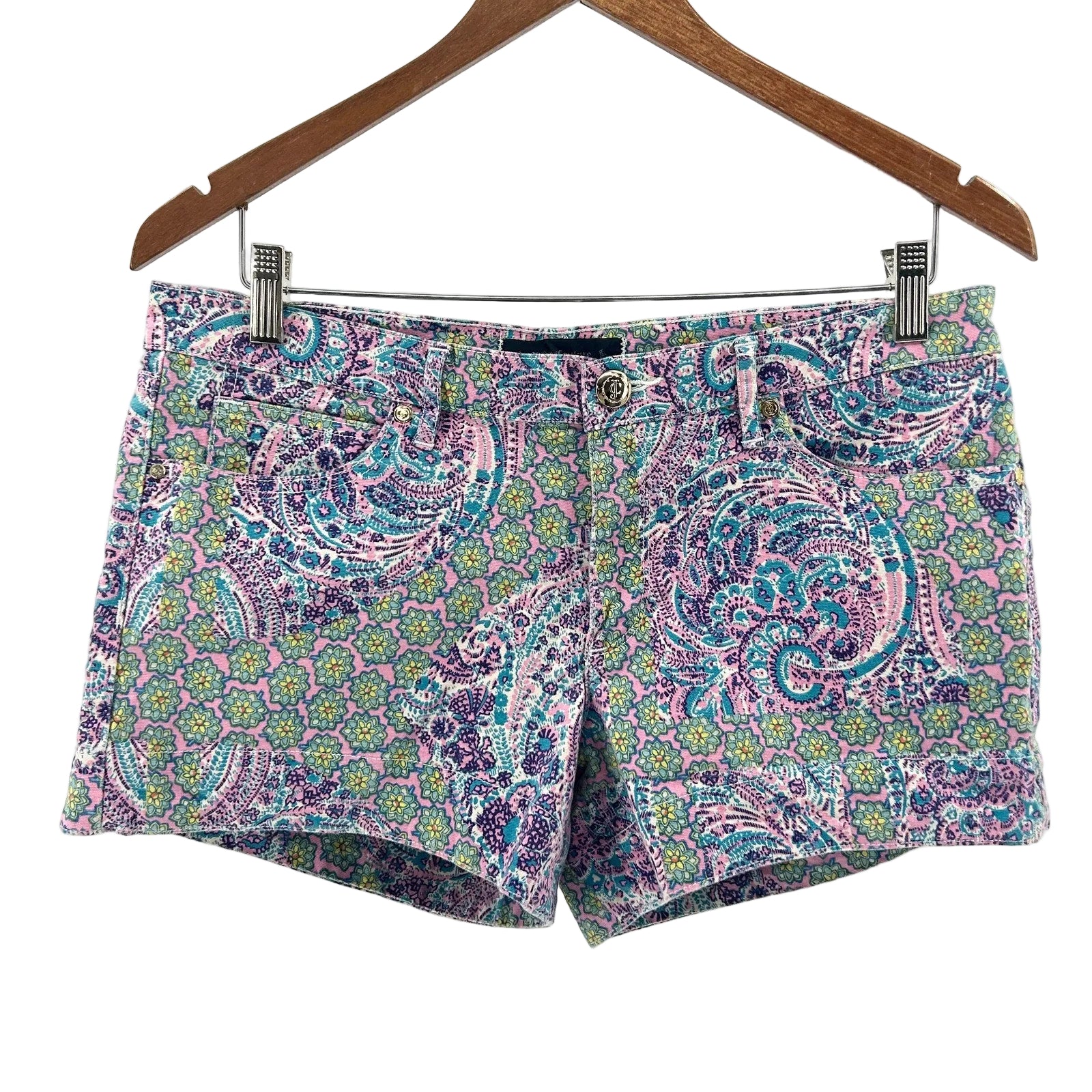 Colorful patterned shorts on a hanger against a white background