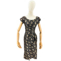 Black floral dress on a mannequin against a white background