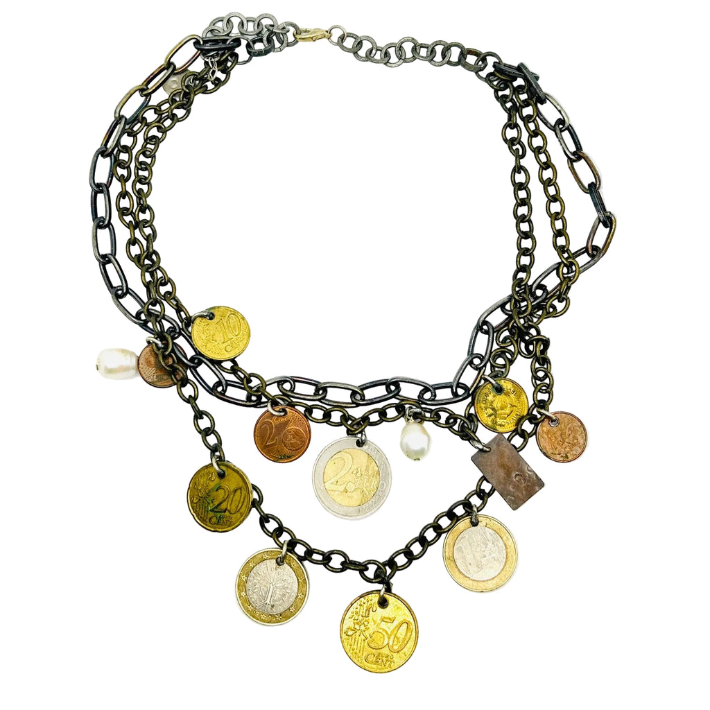 Necklace with coins and charms on a white background